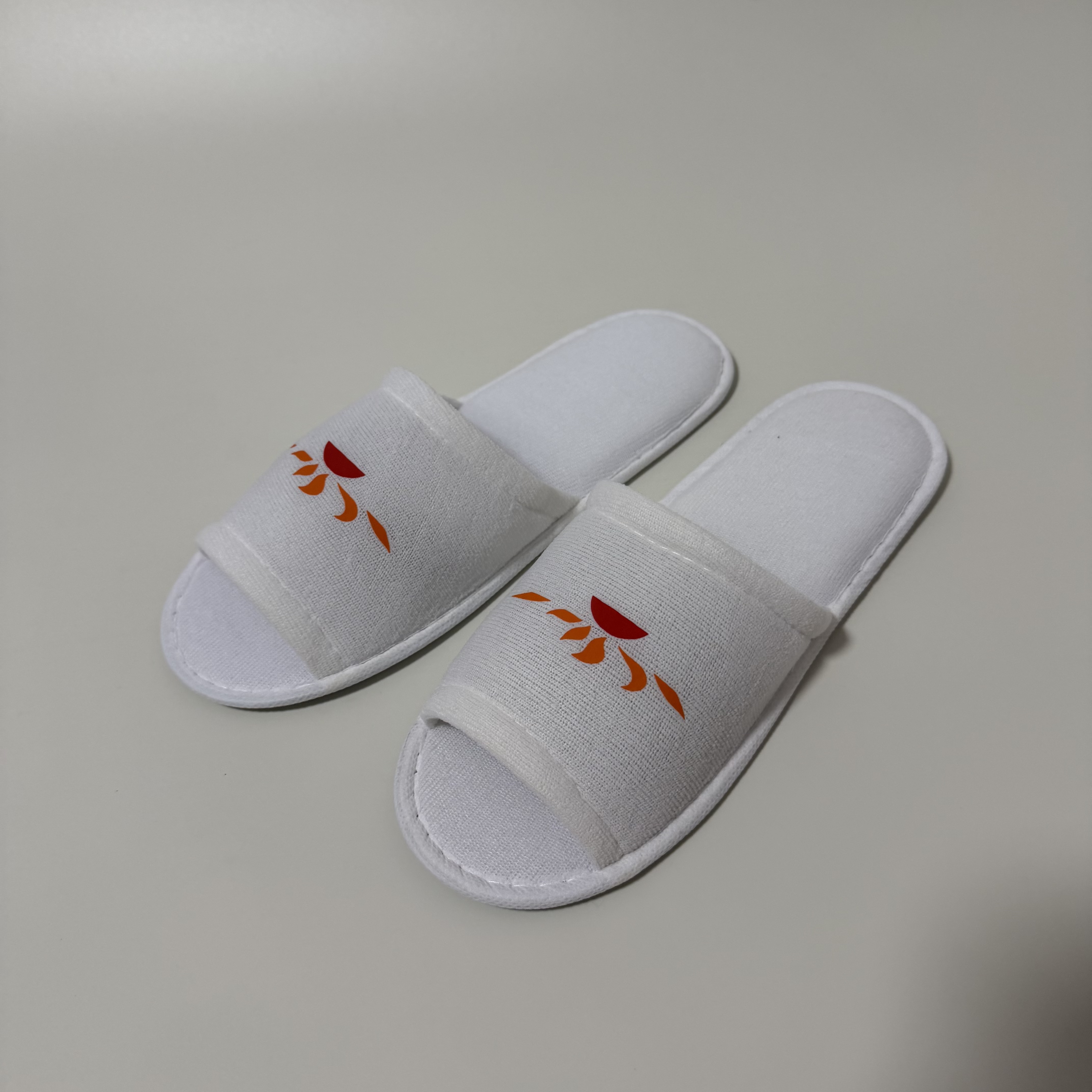 Custom White Open Toe Terry Hotel Slippers Manufacturer | Wholesale Printed Logo Hospitality Slippers