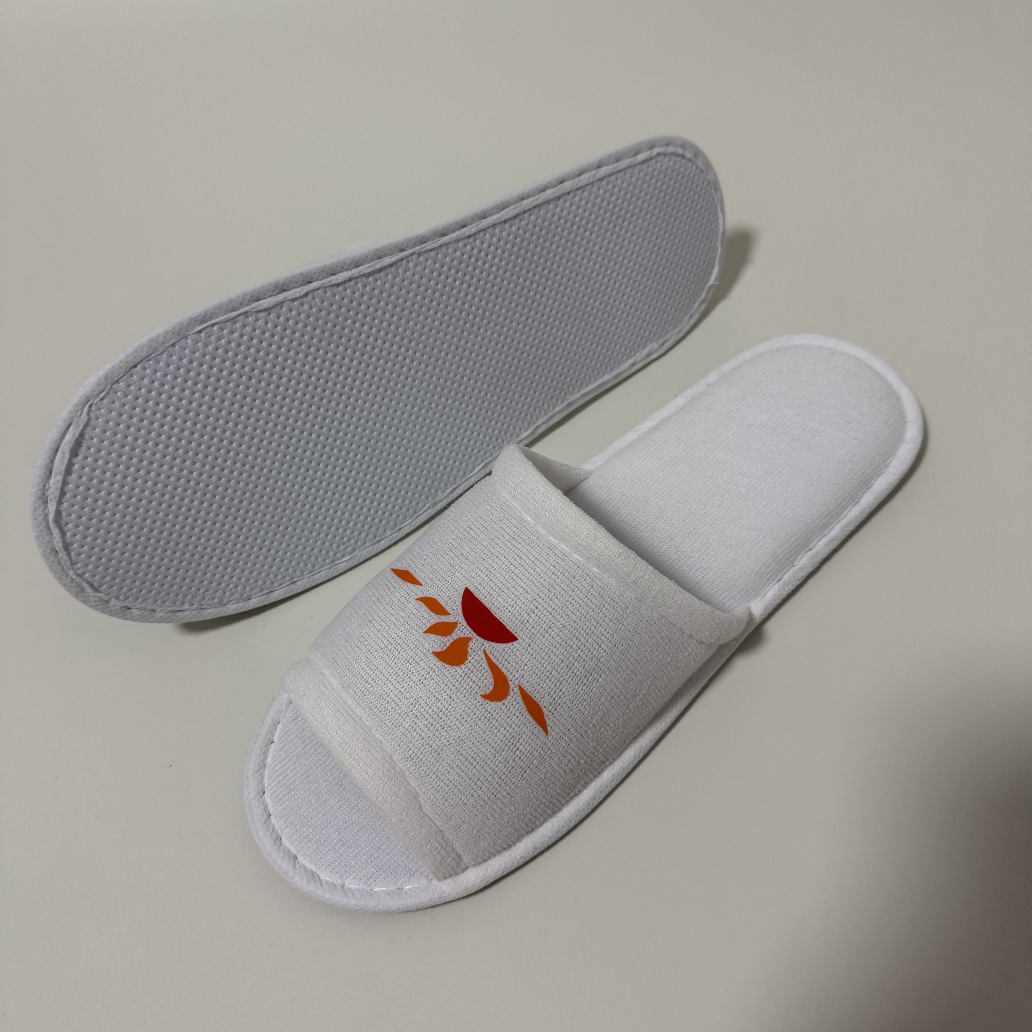 Custom White Open Toe Terry Hotel Slippers Manufacturer | Wholesale Printed Logo Hospitality Slippers